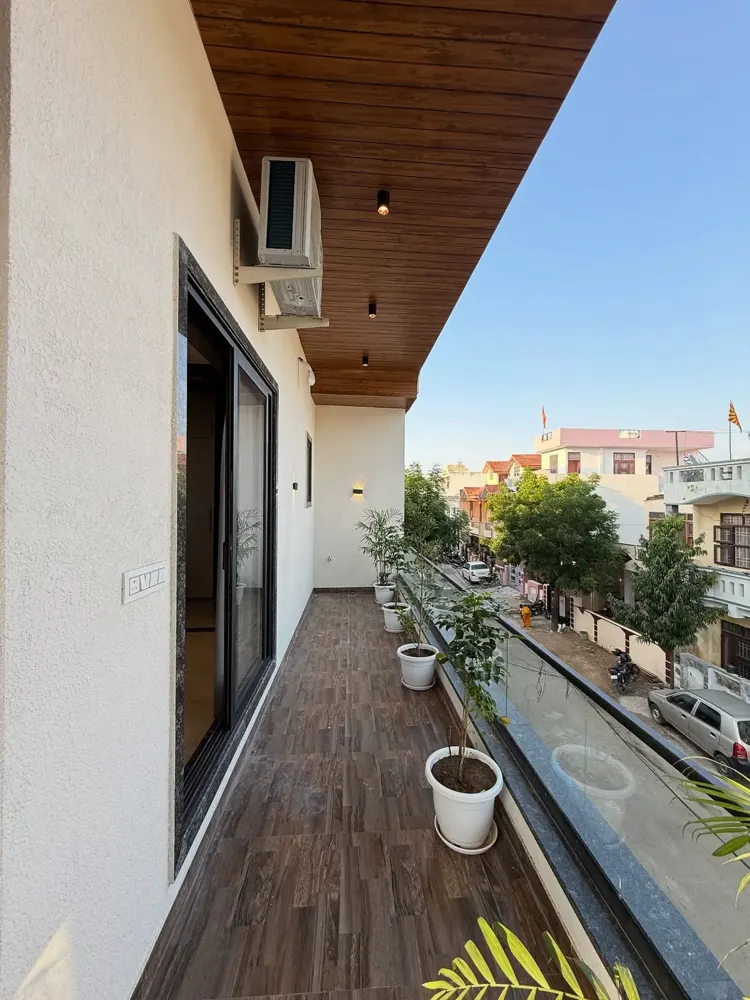 Balcony with wooden ceiling and a clean finished exterior wall